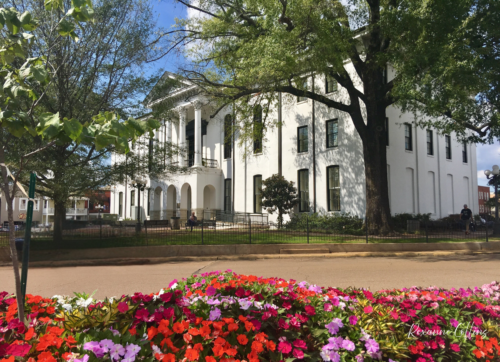 white historic building surrounded by spring flowers